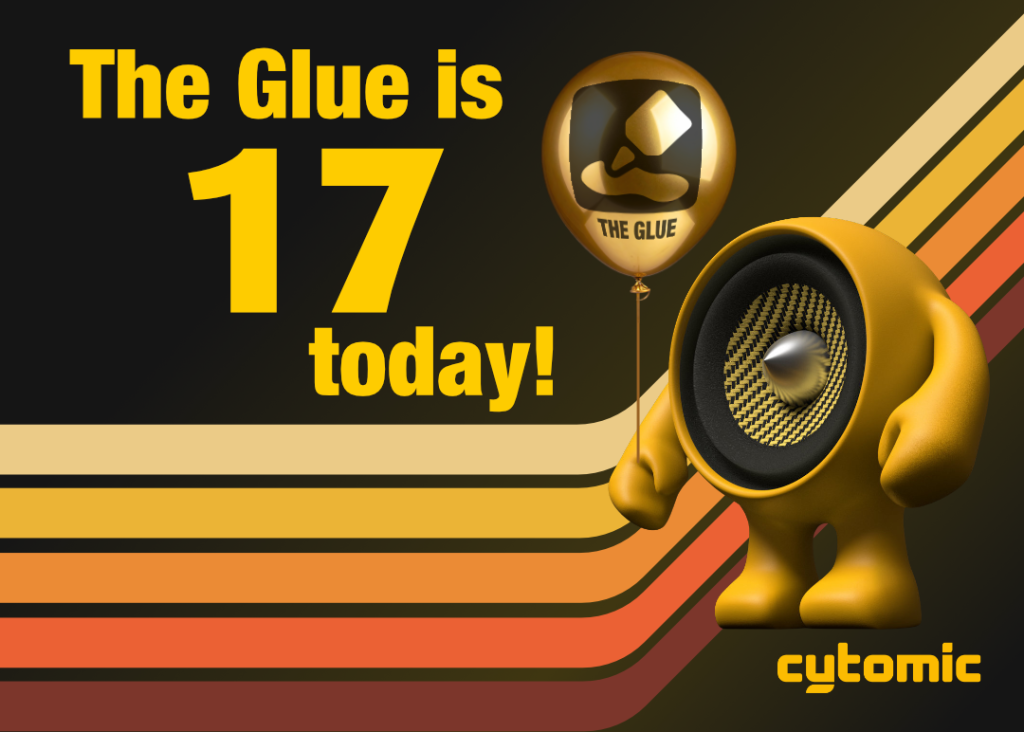 Image of Cytom, Cytomic's speaker logo, holding a shiny gold helium balloon with The Glue logo on it, against black background with 70s style racing stripes of different warm colours and text reads "The Glue is 17 today!"